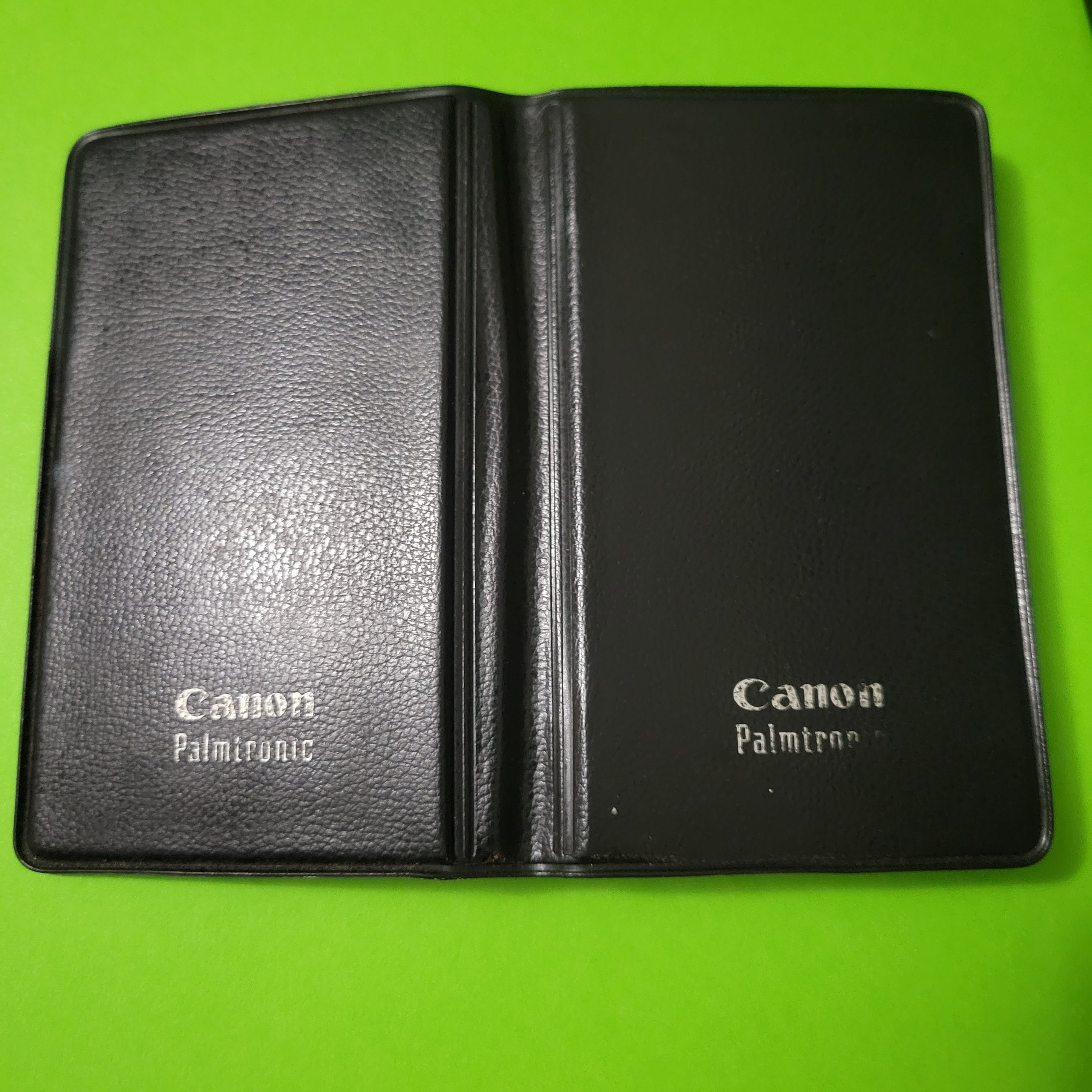 An image of the case of a Canon Palmtronic 8s four function plus calculator